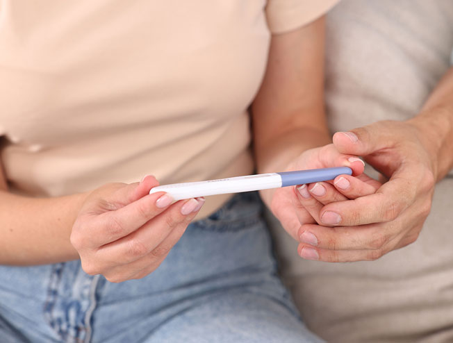 Family checking pregnancy test