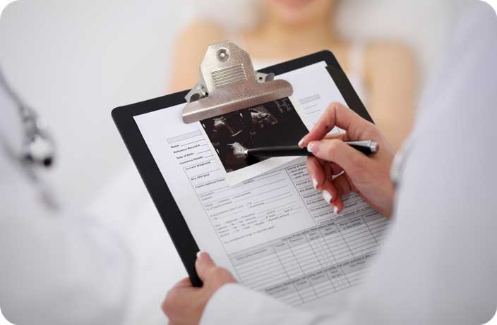 Fertility specialist reviewing medical information during a consultation