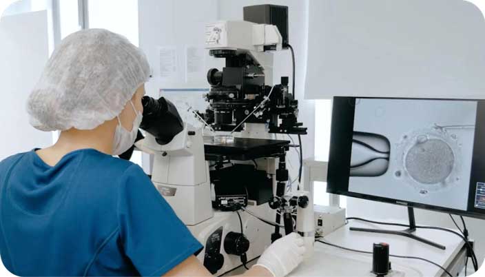 Embryologist performing an ICSI procedure in a fertility laboratory